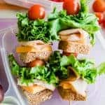 Sandwich kabobs showing whole wheat bread, cheese, turkey, lettuce, and tomato.