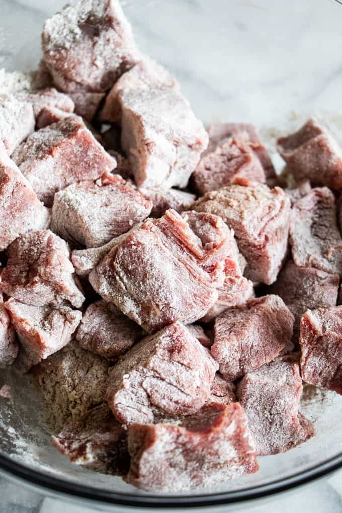 Chuck roast cut into 1 inch pieces and coated in flour, salt and pepper to be seared for beef stew.