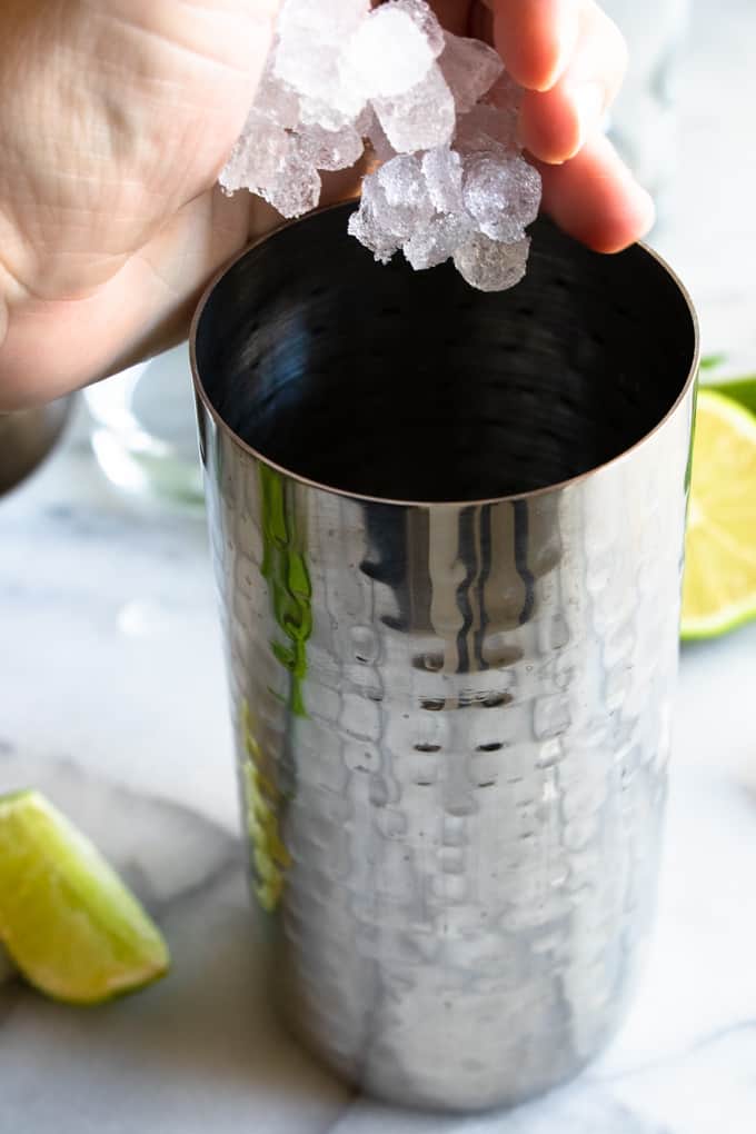 Add the ice to the shaker to make a classic mojito!