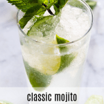 Classic mojito served with a sprig of mint and lime wedges.