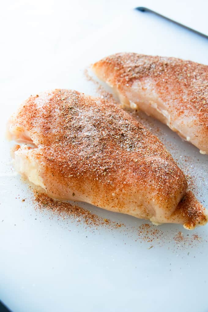 Chicken rubbed with homemade chicken taco seasoning ready to cook for chicken tacos.