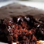 Close up of the tender crumb of a chocolate Texas Sheet Cake with fudgy icing on top.