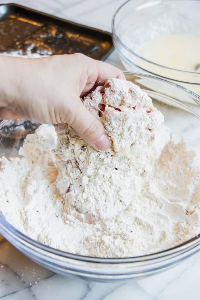 How to make chicken fried steak: pulling the steak from the second dipping into the flour mixture.