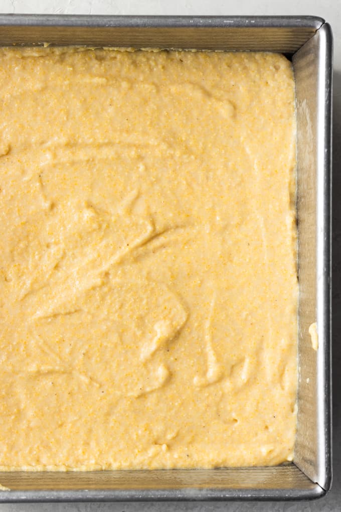 Cornbread batter poured into a baking dish ready to cook.