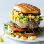 Taco Burger loaded up with guacamole and homemade peach salsa.