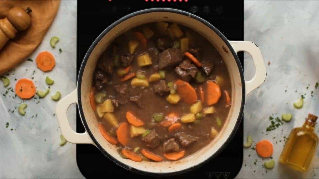 Dutch oven filled with beef stew to simmer. 
