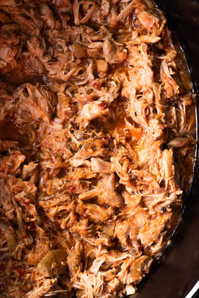 Pot filled with Chicken Tinga, shredded chicken in a chipotle sauce. 