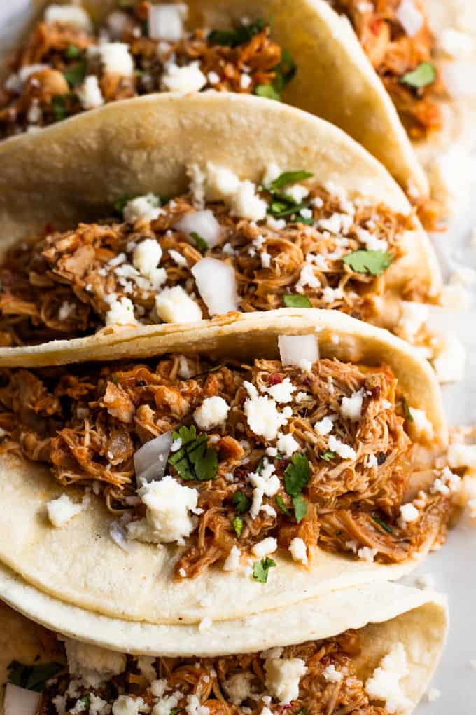 Homemade slow cooker Chicken Tinga loaded into tacos. 