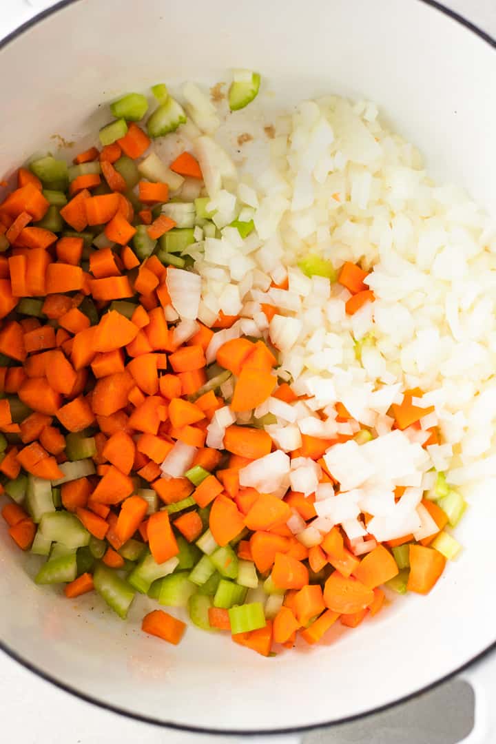 Carrots, celery and onion diced and in a stockpot to make chicken and dumplings.