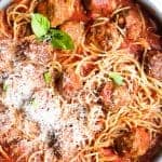 Skillet filled with homemade spaghetti and meatballs.