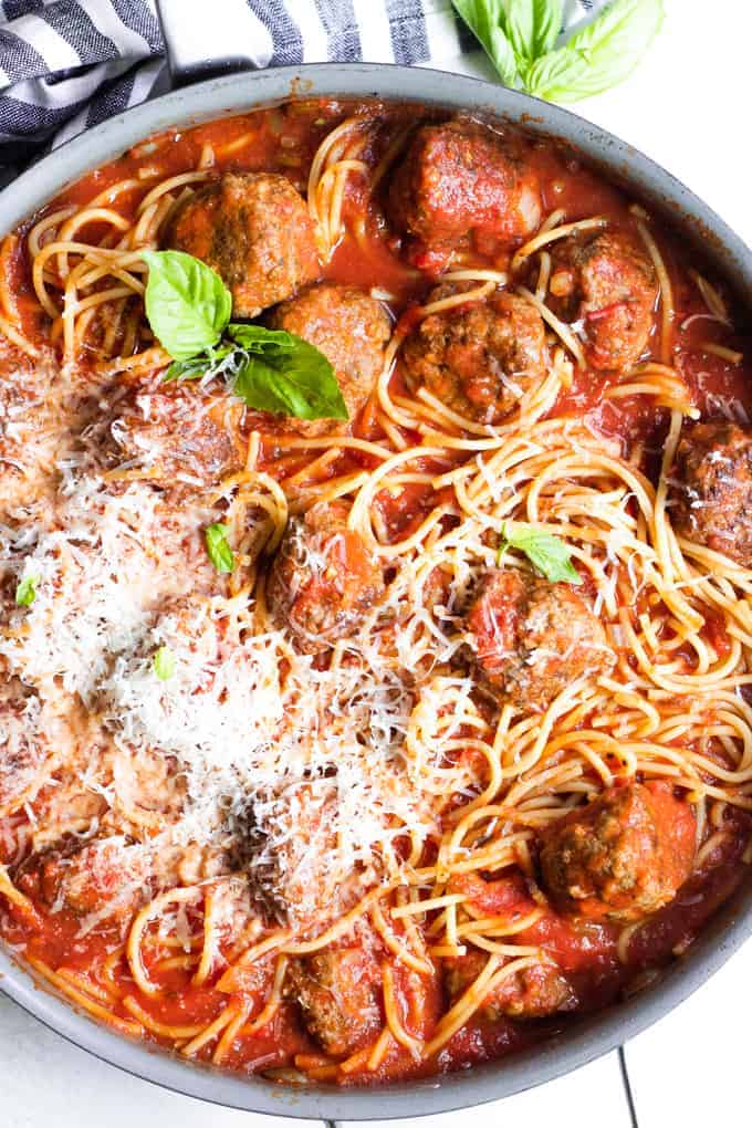 Skillet filled with homemade spaghetti and meatballs.