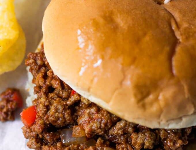 Toasted hamburger bun topped with ground beef coated in a sloppy Joe sauce.