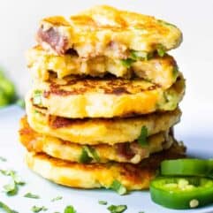 Stack of mashed potato cakes loaded with jalapeno, bacon and cheese.