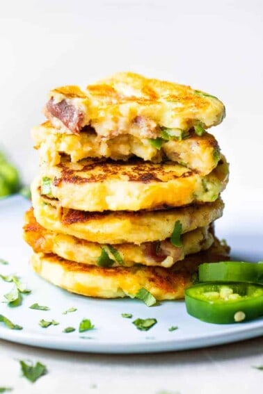 Stack of mashed potato cakes loaded with jalapeno, bacon and cheese.