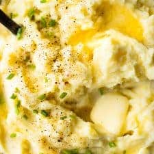 Close up of butter melting on a pile of mashed potatoes.