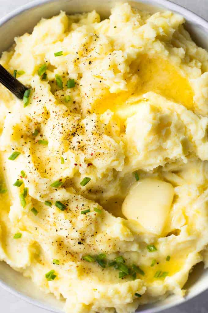 Close up of butter melting on a pile of mashed potatoes. 