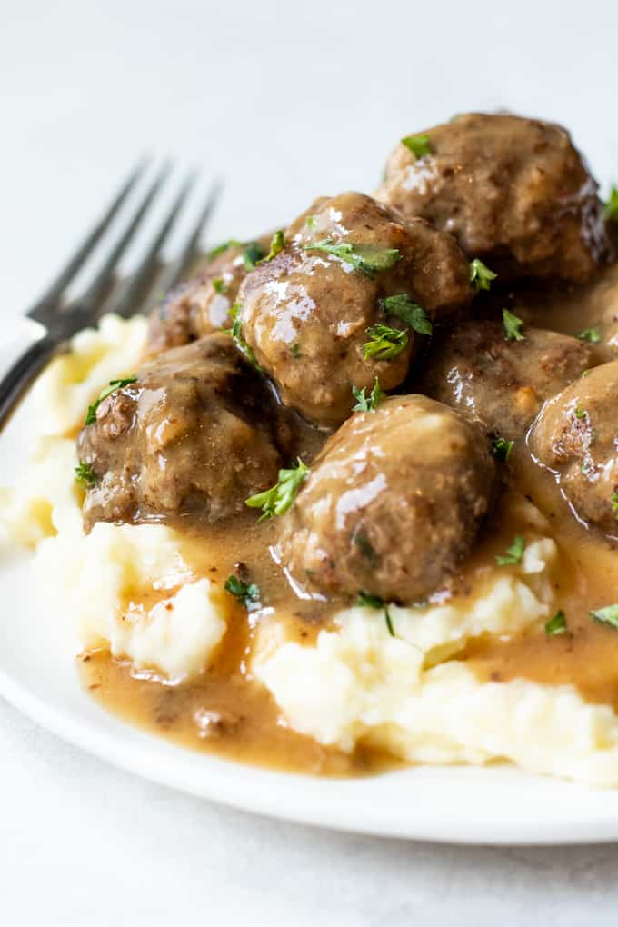 Swedish meatballs served on top of creamy mashed potatoes.