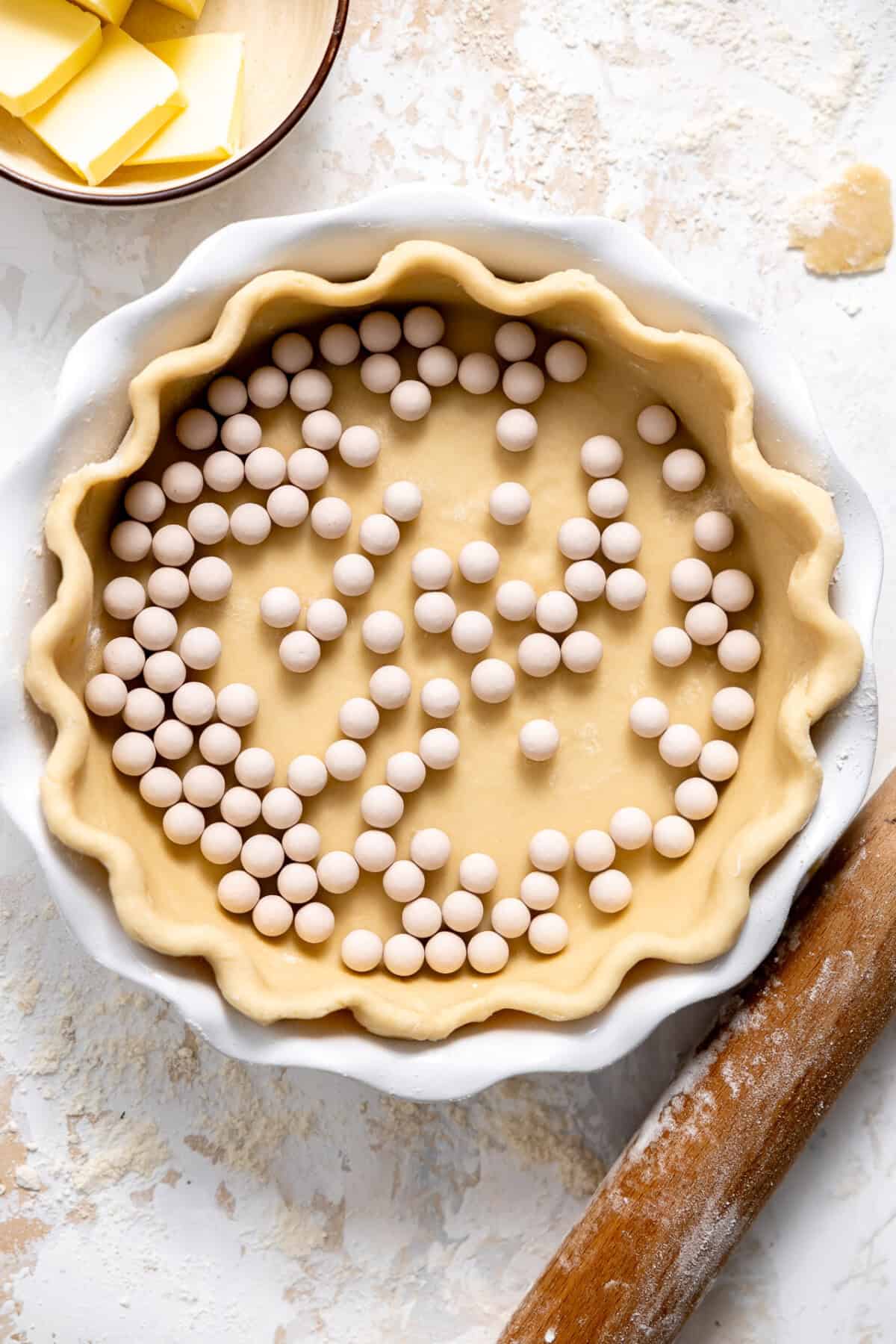 Pie crust filled with pie crust weights for blind baking. 