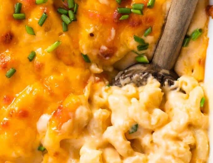 Spoon serving up homemade baked macaroni and cheese.