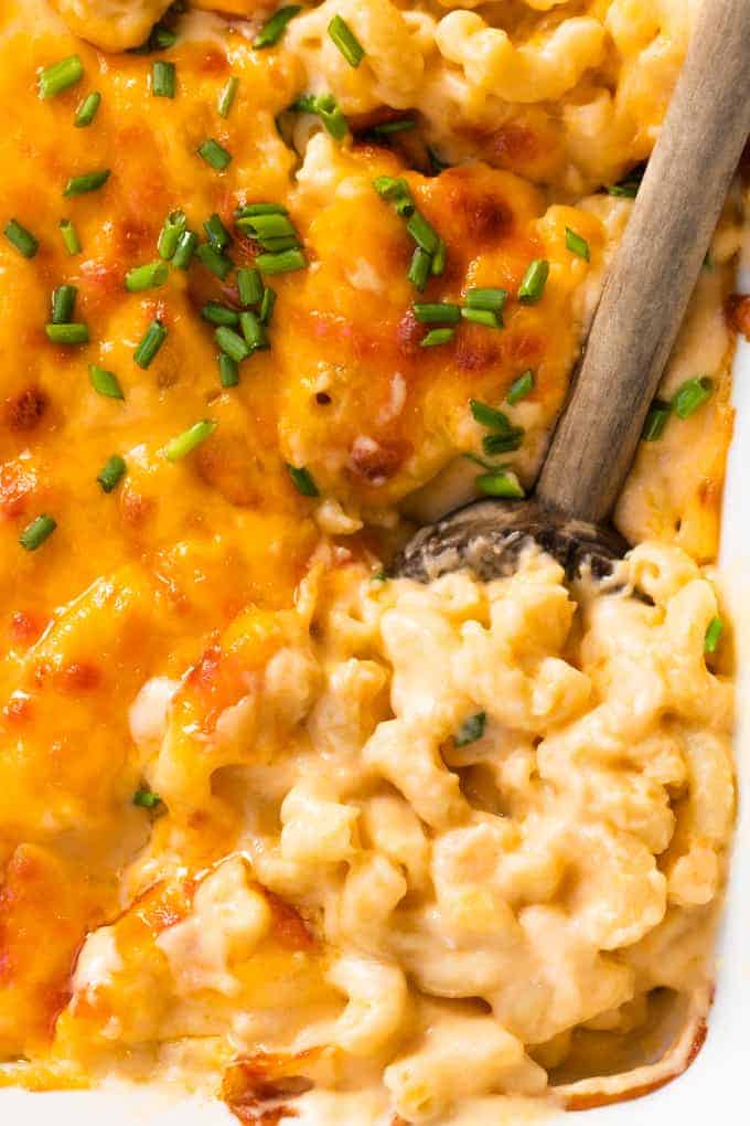 Spoon serving up homemade baked macaroni and cheese.