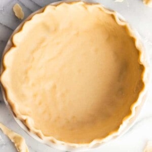 Pie crust fluted in a pie dish.