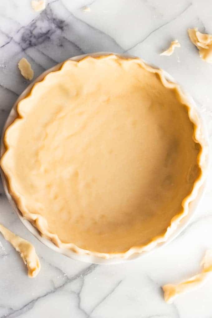 Pie crust fluted in a pie dish.