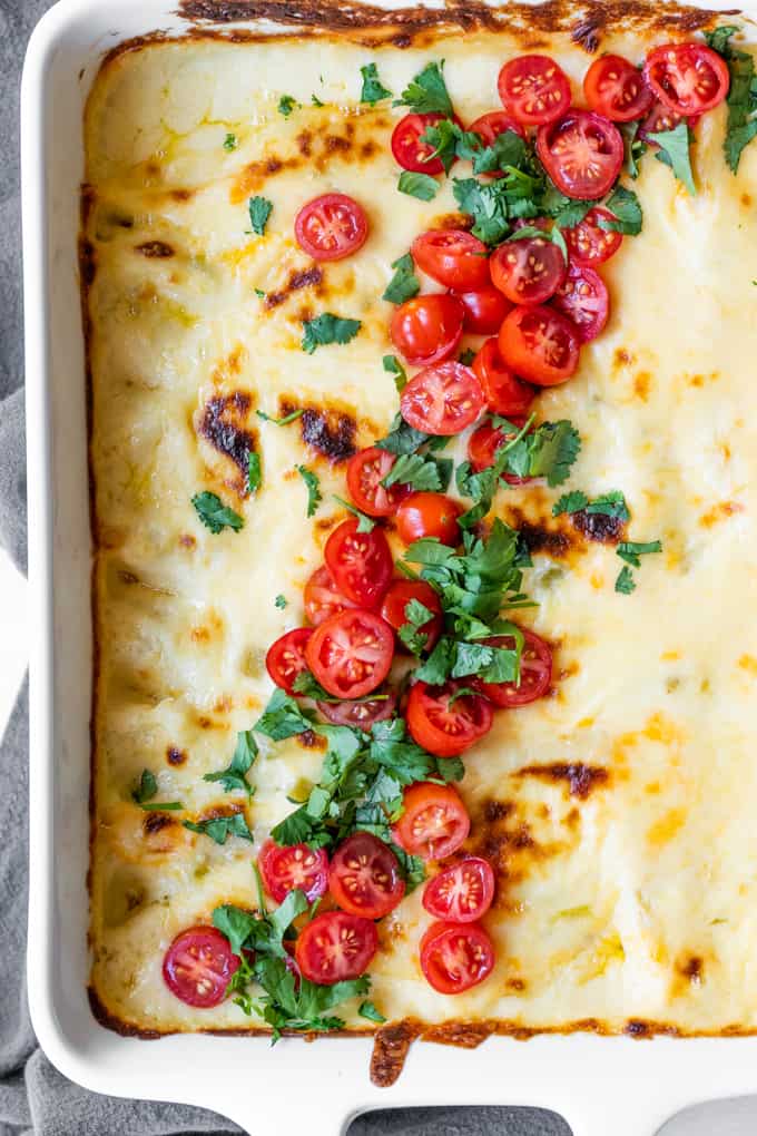 Breakfast Enchiladas topped with diced tomato and cilantro.