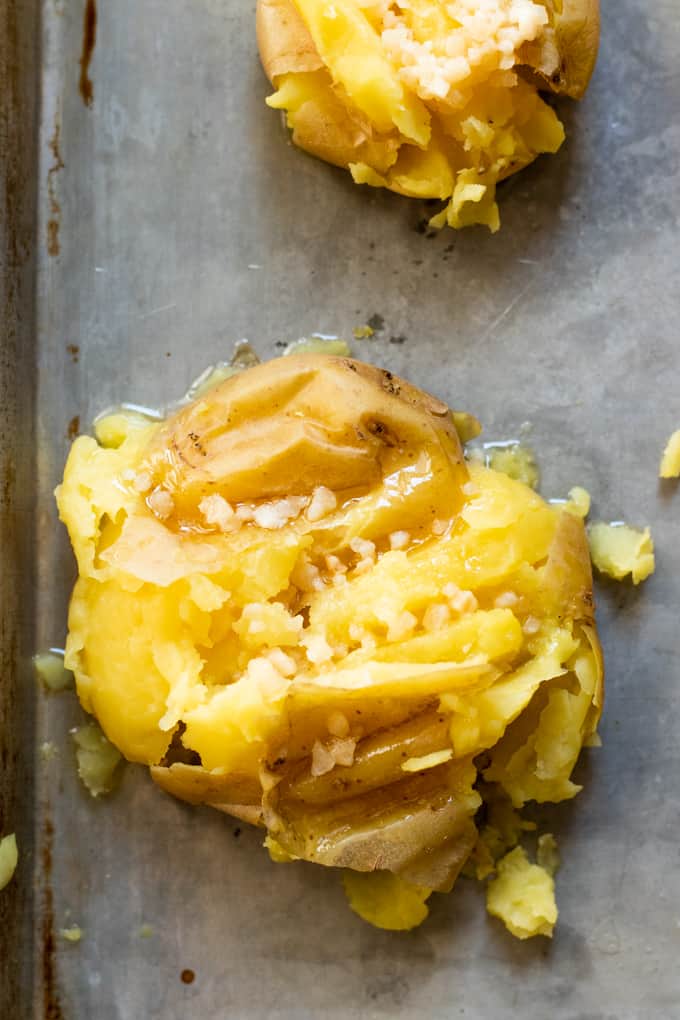Small gold potato, smashed and drizzled with butter and garlic.
