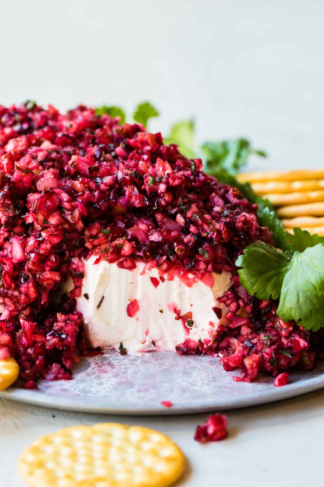 Cranberry salsa served over a block of cream cheese and served with crackers.