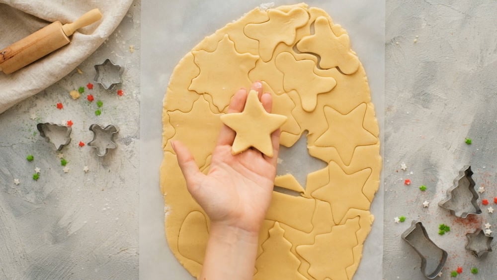 Shapes cut out of sugar cookie dough. 
