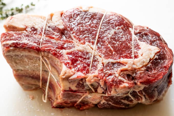 Prime Rib roast after sitting at room temperature for 2 hours after being salted, showing the juices coming out.