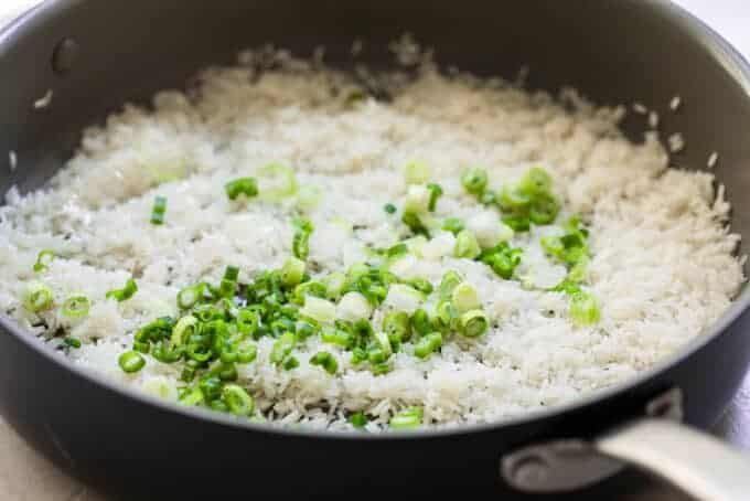 Rice toasting with green onion in oil.
