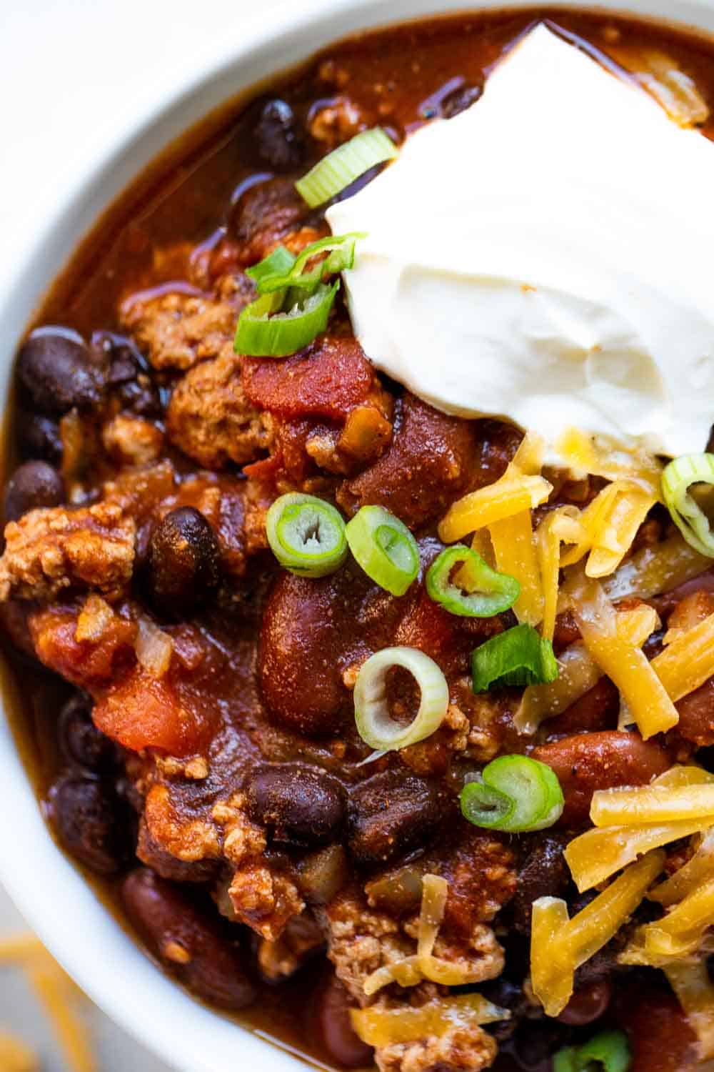 Up close look at turkey chili, showing chunks of ground turkey and beans