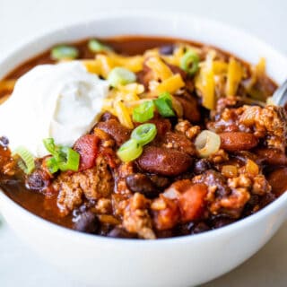 White bowl filled with red turkey chili.