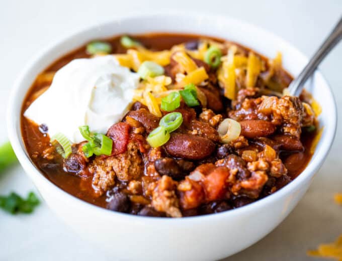 White bowl filled with red turkey chili.