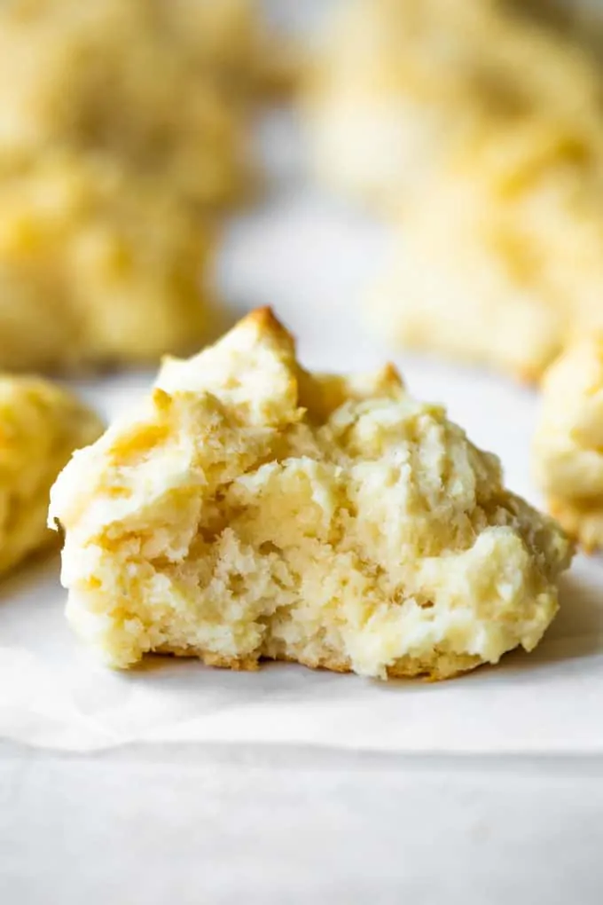 Buttermilk drop biscuit in half showing tender, soft baked bread on the inside.