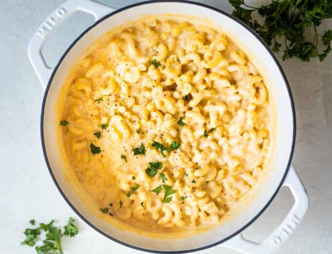 Large white dutch oven filled with homemade Mac and cheese.