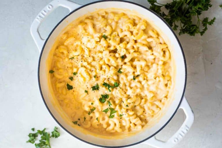 Large white dutch oven filled with homemade Mac and cheese.