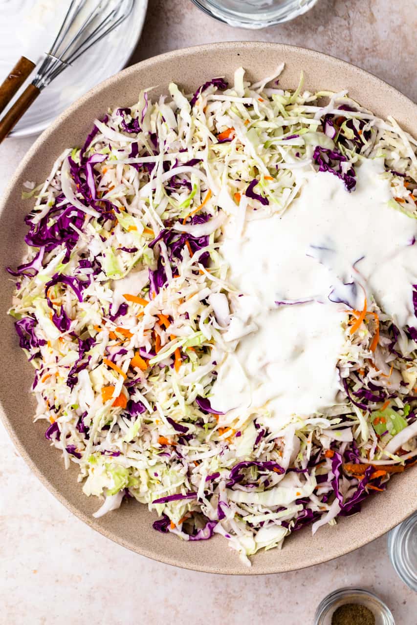 Fresh shredded cabbage with coleslaw dressing poured over the top. 