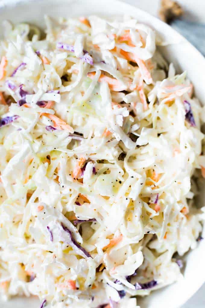 Bowl filled with creamy coleslaw made with tri color mix. 