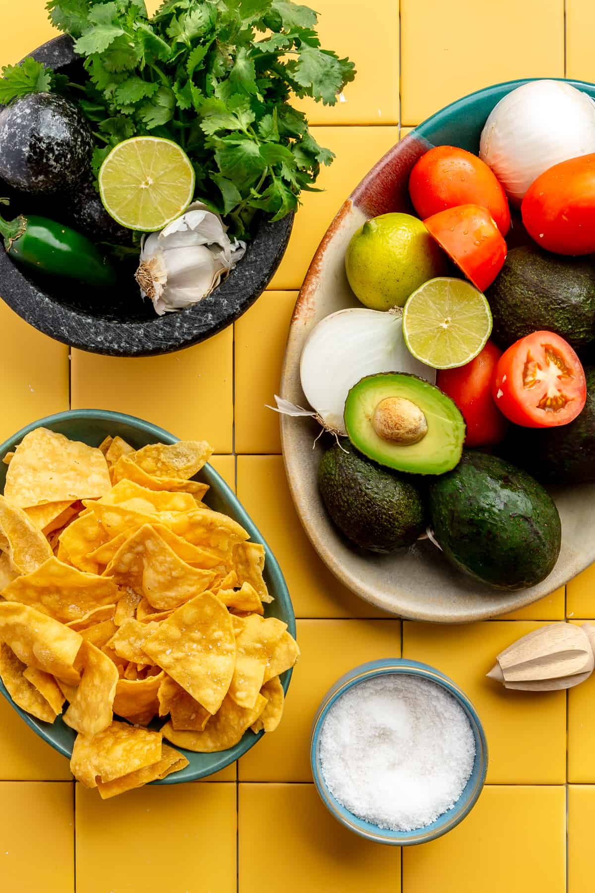 Ingredients needed to make homemade guacamole laid out on the counter. 