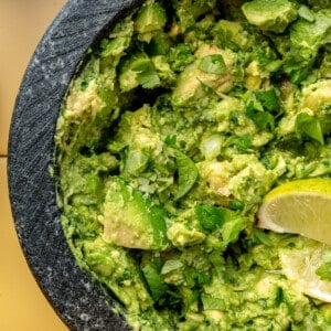 Up close image of guacamole in a molcajete.