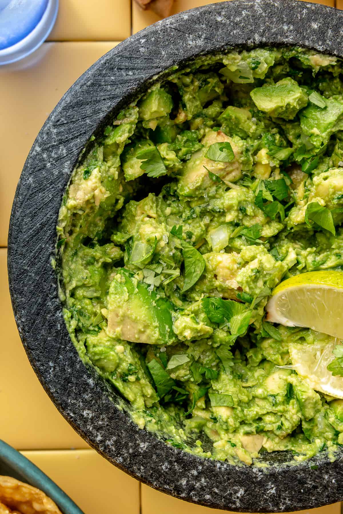 Up close image of guacamole in a molcajete. 