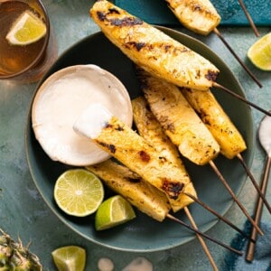Grilled pineapple served with a coconut rum sauce.