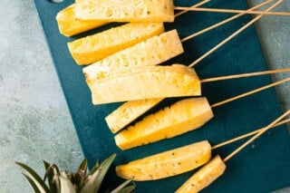 Sliced pineapple on skewers.