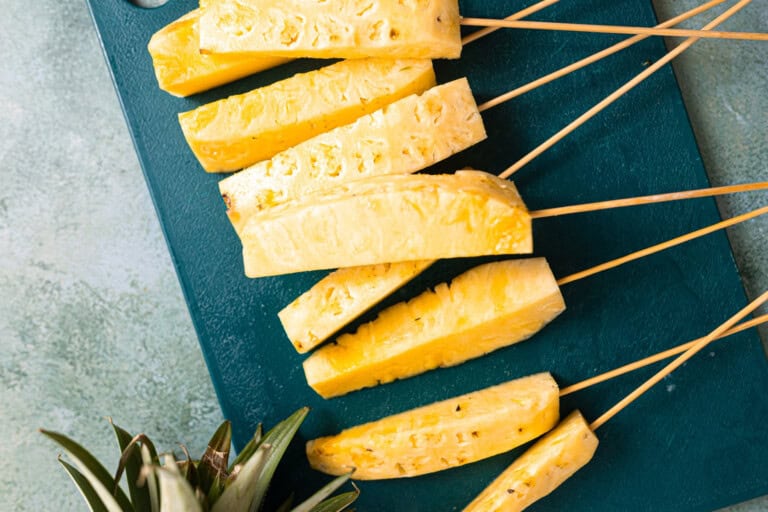 Sliced pineapple on skewers.