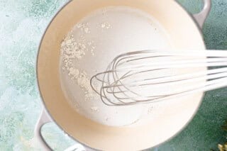 Coconut cream, milk, and rum in a saucepan to make a sauce.