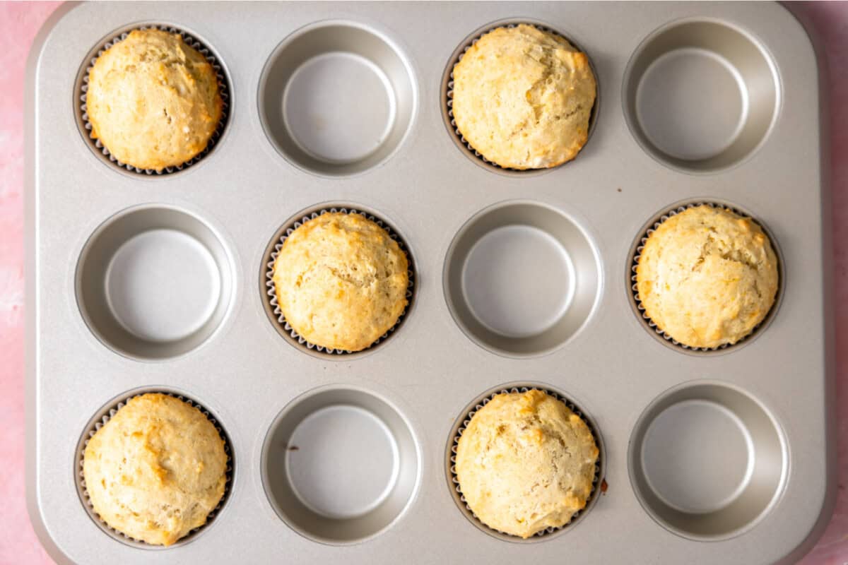 Baked lemon muffins in a muffin tin. 