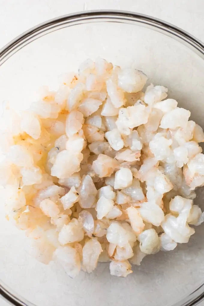 Raw shrimp that has been chopped for shrimp ceviche.