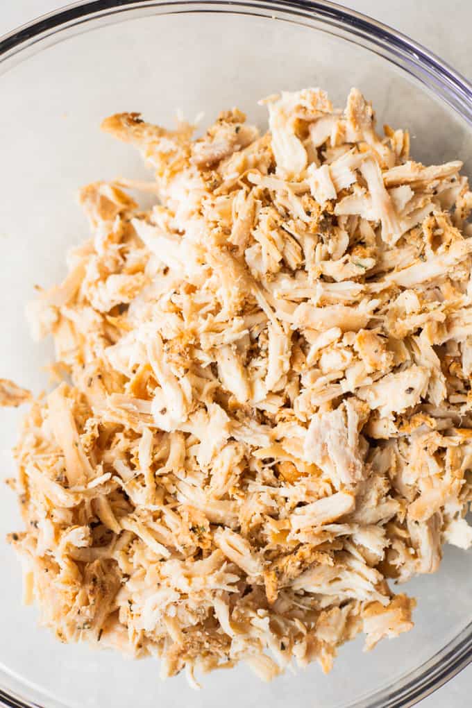 Bowl filled with shredded chicken.